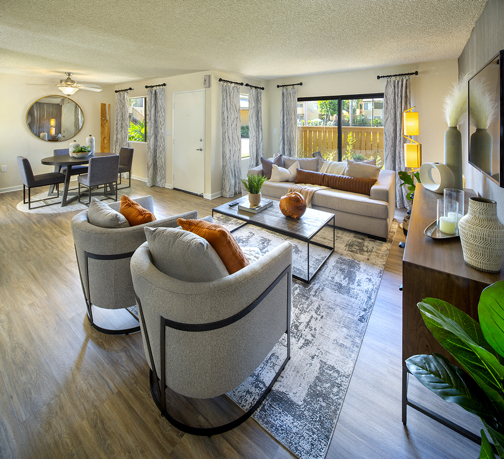 a living room with couches and chairs and a table